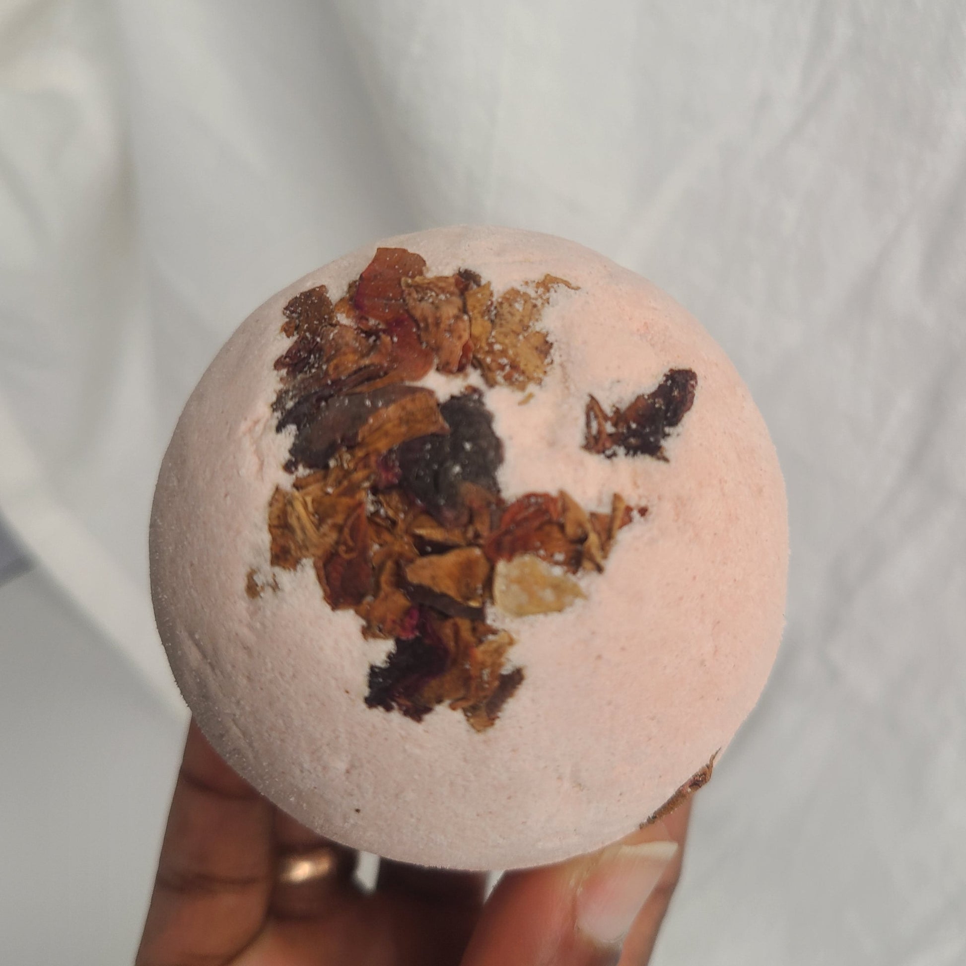 Handmade bath bomb with peppermint essential oil and dry rose petals